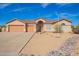 Charming single-story home with a three-car garage, desert landscaping, and clear blue skies at 730 E Tanya Trl, Phoenix, AZ 85086