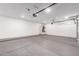 Spacious garage features a cement floor, white walls, and overhead lighting at 730 E Tanya Trl, Phoenix, AZ 85086