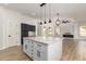 Bright kitchen with a large island, marble countertops, and black pendant lights creating a stylish space at 730 E Tanya Trl, Phoenix, AZ 85086