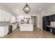 Open kitchen has a large island, stainless steel appliances, and black and white accents at 730 E Tanya Trl, Phoenix, AZ 85086