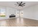 Open living room has hardwood floors, an electric fireplace, and neutral colors with views of the backyard at 730 E Tanya Trl, Phoenix, AZ 85086
