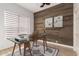 Stylish office with a wood accent wall, modern desk, and a large window offering natural light at 730 E Tanya Trl, Phoenix, AZ 85086