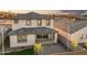 Aerial view of a home with a brick-paved backyard, covered patio, and well-manicured lawn at 7441 W Buckhorn Trl, Peoria, AZ 85383