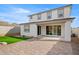 Beautiful backyard featuring a covered patio, neatly placed turf, and privacy wall at 7441 W Buckhorn Trl, Peoria, AZ 85383
