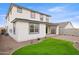 Spacious backyard with brick patio, lush artificial turf, and well-maintained landscaping at 7441 W Buckhorn Trl, Peoria, AZ 85383