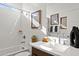 Bright bathroom with a shower-tub combination, modern sink, decorative elements, and a neutral color palette at 7441 W Buckhorn Trl, Peoria, AZ 85383
