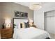 Inviting bedroom with contemporary decor, including a decorative lamp, modern art, and a closet at 7441 W Buckhorn Trl, Peoria, AZ 85383