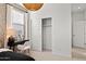 Bright bedroom featuring modern vanity and closet with sliding doors at 7441 W Buckhorn Trl, Peoria, AZ 85383