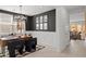 Stylish home office featuring dark accent walls, modern decor, and an open view into the living area at 7441 W Buckhorn Trl, Peoria, AZ 85383