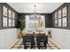 Elegant home office featuring dark walls, wainscoting, decorative lighting, and a spacious work area at 7441 W Buckhorn Trl, Peoria, AZ 85383