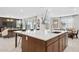 Open-concept kitchen island with quartz countertops, stainless steel appliances, and seamless flow to the living area at 7441 W Buckhorn Trl, Peoria, AZ 85383