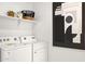 Modern laundry room with white washer and dryer and decorative accents at 7441 W Buckhorn Trl, Peoria, AZ 85383