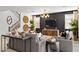 Comfortable living area features modern decor, stylish lighting, and elegant staircase to the second floor at 7441 W Buckhorn Trl, Peoria, AZ 85383