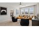 Bright living room with a comfortable yellow sofa, beanbag chairs, and large windows providing abundant natural light at 7441 W Buckhorn Trl, Peoria, AZ 85383