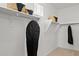 Bright walk-in closet with shelving, closet rods, and storage baskets at 7441 W Buckhorn Trl, Peoria, AZ 85383