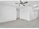 Spacious bedroom with neutral carpeting, fan, and bright white walls at 7961 W Desert Blossom Way, Florence, AZ 85132