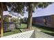 Spacious backyard featuring a mural, outdoor seating, and well-maintained green turf at 891 W Moon Shadow Dr, Casa Grande, AZ 85122