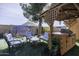 Outdoor area with a gazebo, grill, and a decorative mural on the block wall at 891 W Moon Shadow Dr, Casa Grande, AZ 85122