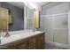 Bathroom featuring a double sink vanity and a glass-enclosed shower at 891 W Moon Shadow Dr, Casa Grande, AZ 85122