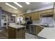Bright kitchen featuring stainless steel appliances, an island, and view to the dining and laundry rooms at 891 W Moon Shadow Dr, Casa Grande, AZ 85122