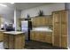 Spacious kitchen offering ample counter space, stainless steel appliances, and abundant wooden cabinetry at 891 W Moon Shadow Dr, Casa Grande, AZ 85122