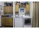 Bright laundry room featuring a modern washer and dryer with ample cabinet storage space at 891 W Moon Shadow Dr, Casa Grande, AZ 85122