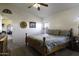 Comfortable bedroom with a ceiling fan, neutral walls, and good natural light at 891 W Moon Shadow Dr, Casa Grande, AZ 85122