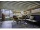 Sunroom showcasing a seating area, tile floors, and views of the backyard at 891 W Moon Shadow Dr, Casa Grande, AZ 85122