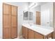 Bathroom featuring wood cabinetry, white countertops, mirror and wood cabinets at 900 S 94Th St # 1203, Chandler, AZ 85224