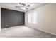 This bedroom features a neutral-toned wall, a ceiling fan and a large window for natural light at 900 S 94Th St # 1203, Chandler, AZ 85224