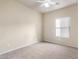 Bright bedroom with neutral carpet, ceiling fan, and window for natural light at 900 S 94Th St # 1203, Chandler, AZ 85224