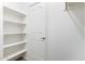 Walk-in closet with built-in white shelving with a hanging rod and a white door at 900 S 94Th St # 1203, Chandler, AZ 85224