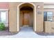 Close up of a condo entrance with a brown door, arched entryway, and the unit number displayed at 900 S 94Th St # 1203, Chandler, AZ 85224