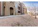 Multi-story condo building featuring colorful facades, private arched entryways, and desert landscaping at 900 S 94Th St # 1203, Chandler, AZ 85224
