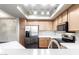 Modern kitchen with stainless steel appliances and wood cabinets at 900 S 94Th St # 1203, Chandler, AZ 85224