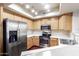 Well-lit kitchen features stainless steel appliances and wood cabinets at 900 S 94Th St # 1203, Chandler, AZ 85224