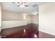Open living room with dark hardwood floors and multiple ceiling fans at 900 S 94Th St # 1203, Chandler, AZ 85224