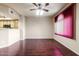 Bright living room featuring hardwood floors, a ceiling fan, and a view into the kitchen at 900 S 94Th St # 1203, Chandler, AZ 85224