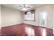 Spacious living room featuring hardwood floors, a ceiling fan, and a glass door at 900 S 94Th St # 1203, Chandler, AZ 85224