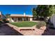 Spacious backyard featuring a manicured lawn, desert landscaping, mature trees, and shaded patio at 9445 S La Rosa Dr, Tempe, AZ 85284