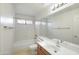 Bathroom featuring a single sink vanity and a shower-tub combo with tile surround at 9445 S La Rosa Dr, Tempe, AZ 85284