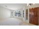 Welcoming entryway boasting neutral carpeting, arched windows, and a stylish, paneled front door at 9445 S La Rosa Dr, Tempe, AZ 85284
