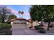 Charming home featuring lush landscaping, two-car garage, and a beautiful tile roof at 9445 S La Rosa Dr, Tempe, AZ 85284