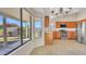 Well-lit kitchen features stainless steel appliances, wooden cabinetry, and large windows with views of the backyard at 9445 S La Rosa Dr, Tempe, AZ 85284