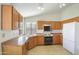 Efficient kitchen layout with wooden cabinetry, modern appliances, and ample counter space at 9445 S La Rosa Dr, Tempe, AZ 85284