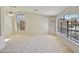 Bright living room features vaulted ceilings, multiple windows with views, and neutral carpeting at 9445 S La Rosa Dr, Tempe, AZ 85284