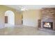Inviting living room featuring a brick fireplace and neutral tile flooring at 9445 S La Rosa Dr, Tempe, AZ 85284