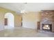 Inviting living room showcasing a brick fireplace, neutral paint, and tiled flooring for easy maintenance at 9445 S La Rosa Dr, Tempe, AZ 85284