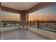 Large balcony with glass railing overlooking a sunset cityscape and golf course at 1040 E Osborn Rd # 1004, Phoenix, AZ 85014