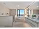 Bright bathroom featuring dual sinks, soaking tub by the window, and a separate shower with neutral tile at 1040 E Osborn Rd # 1004, Phoenix, AZ 85014